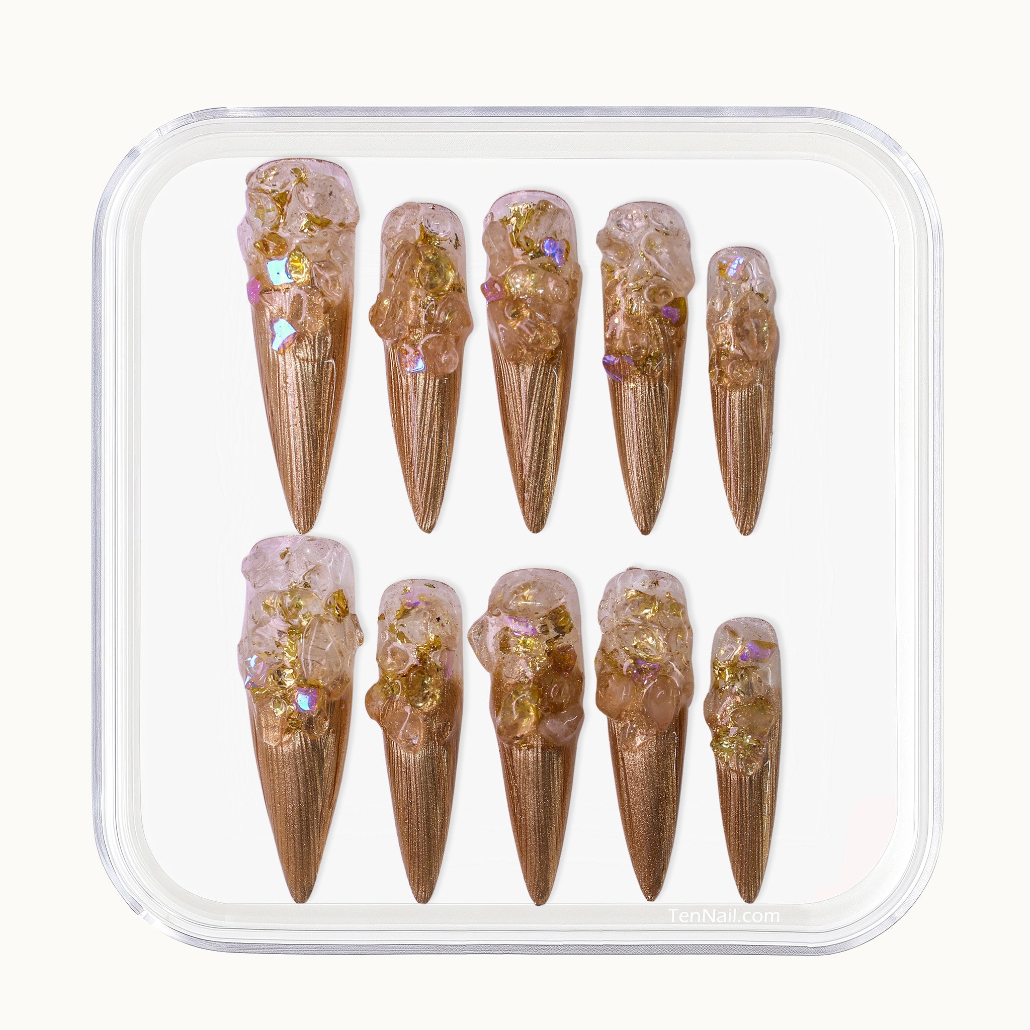 Long Stiletto press-on nails in metallic gold with a clear 3D crushed crystal texture.